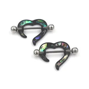 Stainless steel heart nipple ring detail shot, abalone shell inlay body piercing jewelry close-up.