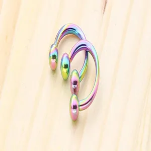 Rainbow stainless steel horseshoe ring body piercing jewelry detail view with ball ends for nose.