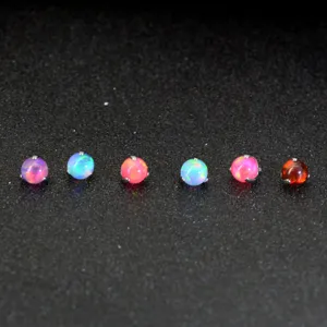 Colorful synthetic opal piercing top, round cabochon titanium labret accessory detail.