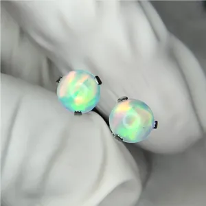 Close-up detail of G23 titanium opal piercing stud, showing vibrant fire color and prong setting.