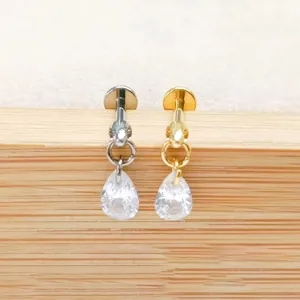 F136 titanium alloy labret stud with teardrop cubic zirconia charm and chain detail for body piercing.