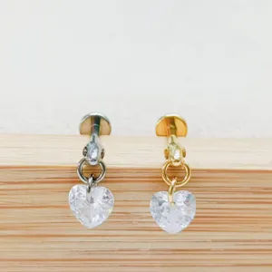 Detailed view of titanium heart zircon labret studs cartilage earrings in silver and gold colors.