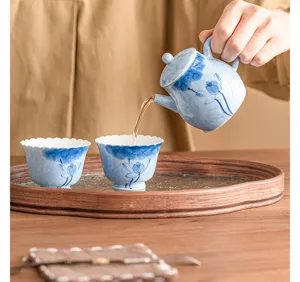 Hand-painted blue lotus ceramic kung fu tea set with teapot and two cups. Perfect for home.