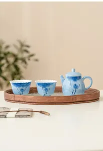 Hand-painted blue lotus ceramic tea set detail, 1 teapot and 2 cups with wood tray for home.