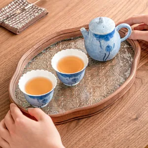 Hand-painted blue lotus ceramic kung fu tea set with one teapot and two cups on wooden tray.