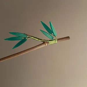 Detailed view of Chinese minimalist bamboo leaf wooden hair stick with elegant green decor.