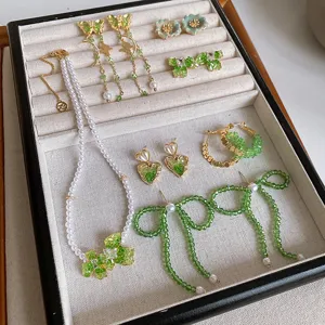 Exquisite green crystal pearl jewelry set including butterfly earrings and necklace for women.