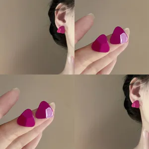 Detail view of minimalist magenta triangle earrings, stylish geometric design for women daily wear.
