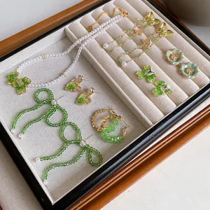 Exquisite green crystal pearl jewelry set featuring bows, flowers, and lovely heart designs.