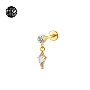 Detail shot of F136 titanium piercing jewelry with a dangling kite stone and round crystal.