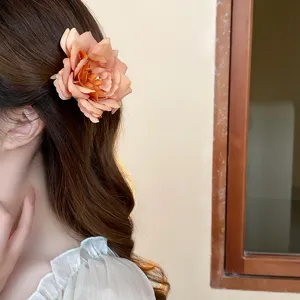 Charming floral duckbill hair clip detail showing the elegant rose design worn on side hair.