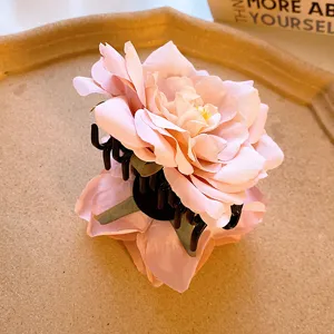 Pink floral hair claw clip, elegant fabric flower shark clip for women and girls daily styling.