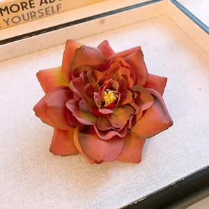 Detailed shot of a dried rose flower hairpin, vintage aesthetic floral side clip.