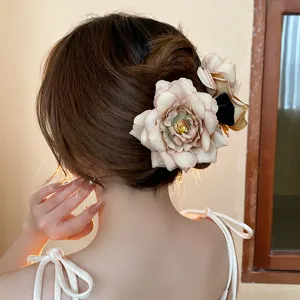 Sweet dried rose flower hair claw clip for women, elegant fabric floral updo shark hair accessory.