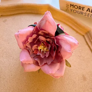 Detailed close-up of sweet pink rose flower hair claw clip, elegant floral design for cute hair styling.