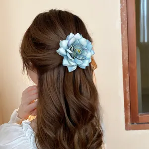 Exquisite blue rose hair clip detail showing floral design and sturdy duckbill clip structure.