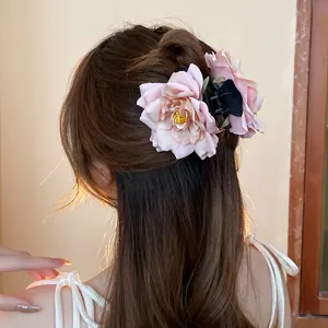 Detail shot of the sweet dry rose flower hair claw, elegant floral shark clip accessory.