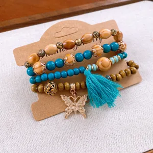 Boho multi-layer wooden bead bracelet set with turquoise beads, tassel, and butterfly.