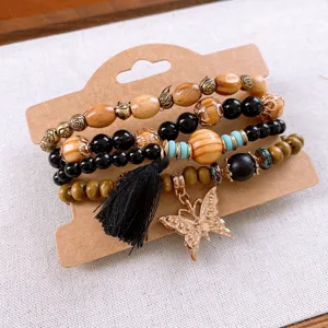 Bohemian multi layer wood bead bracelet with black stone and gold butterfly charm decor.