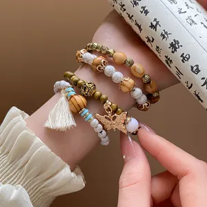Bohemian multi-layer wooden beaded bracelet with tassel and cute butterfly charm for women