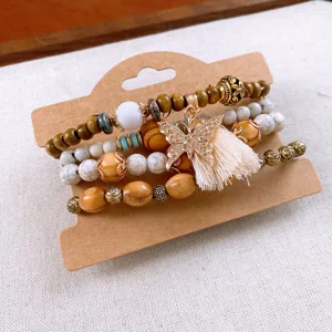 Bohemian multi-layer wooden bead bracelet set featuring chic butterfly tassel detail.