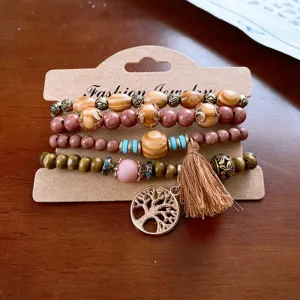 Bohemian multi-layer wooden bead bracelet set with tree pendant and chic tassel charm.
