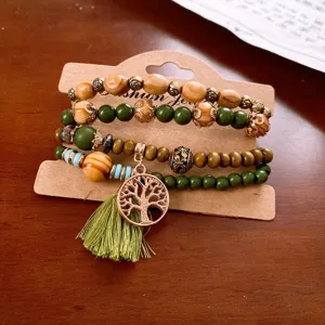 Bohemian multi-layer wooden bead bracelet detail shot with tree charm and green tassel elements.