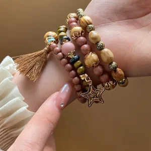 Bohemian multi-layer wooden bead bracelet featuring tassel and star charm for stylish women.