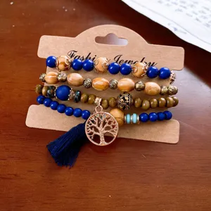 Detailed view of the multi-layer boho wooden bead bracelet with tree of life pendant.