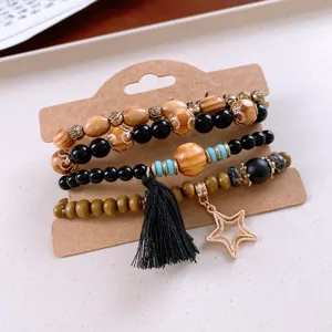 Bohemian multi-layer wooden bead bracelet set with tassel and star pendant for daily wear.