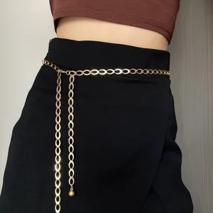 Close-up detail of a stylish gold metal geometric waist chain with dangling ball accent.