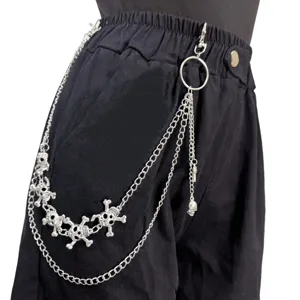 Close-up detail of multi-layer punk metal skull waist chain, stylish hip-hop pants accessory.