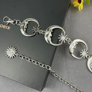 Detailed shot of the punk metal celestial moon and star waist chain, stylish body jewelry.