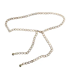 Gold metal geometric chain waist belt detail showcasing vintage links and delicate hanging balls.