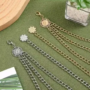 Detailed shot of multi-layer metal body waist chain with vintage sunflower pendant, gold and silver.