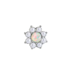 Close-up view of the exquisite floral body piercing stud with opal and pearl details.