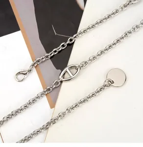 Silver metal waist chain with iconic anchor link design, adjustable body chain jewelry for women.