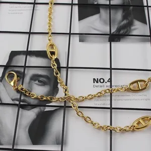 Detailed view of the luxury gold metal chain belt featuring stylish anchor links for women.
