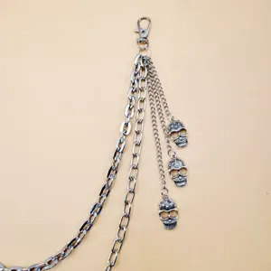 Detailed view of punk metal pants chain with multi-layer chains and skull pendants.