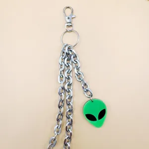Detailed shot of multi-layer hip hop punk pants chain with a green alien pendant and clasp.