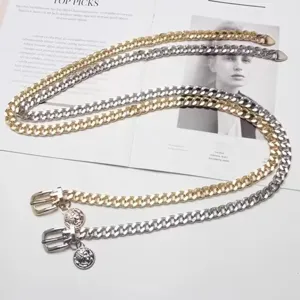 Gold and silver vintage metal chain belt with coin pendant, exaggerated fashion accessory for women.