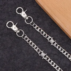 Detail view of silver metal hip-hop thorn chain, cool punk style pants and waist accessory.