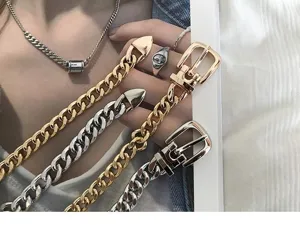 Detail shot of punk style metal chain waist belt, featuring chunky gold and silver links.