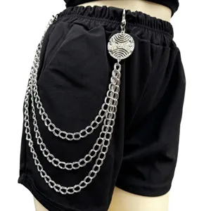 Punk multi-layer metal waist chain detail shot, stylish silver chain with round pendant.