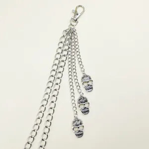 Detailed view of punk metal pants chain with skull charms and lobster clasp for streetwear.