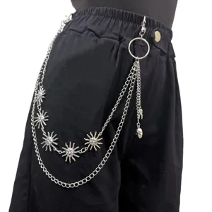 Punk hip hop metal pants chain with sun face and skull pendant, detail view of streetwear.