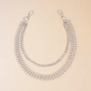 Detail shot of a double layer silver metal chain, punk style waist chain close up view.