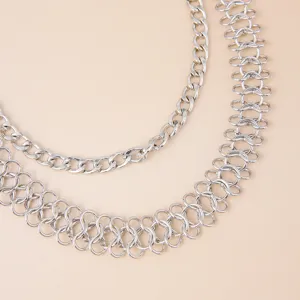 Closeup of multi-layer silver metal waist chain, punk hip-hop pants chain accessory for stylish looks.