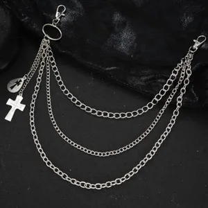 Close up of multi layer punk metal pants chain with cross pendant, detailed chain links.