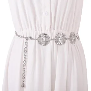 Silver metal waist chain detail showcasing ornate hollow circular medallions on white dress.